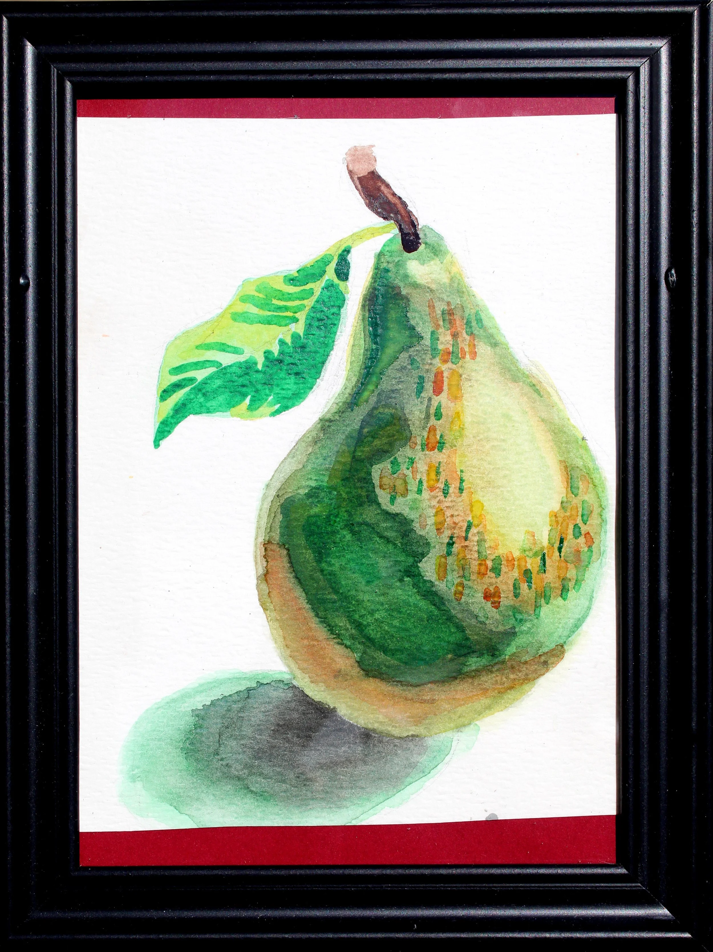 Watercolor painting of a pear with green leaves, framed in black with a red mat.