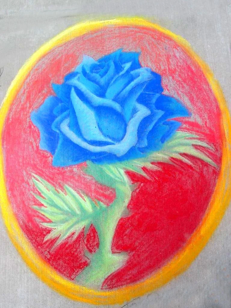 Colorful drawing of a blue rose inside a red and yellow oval shape.