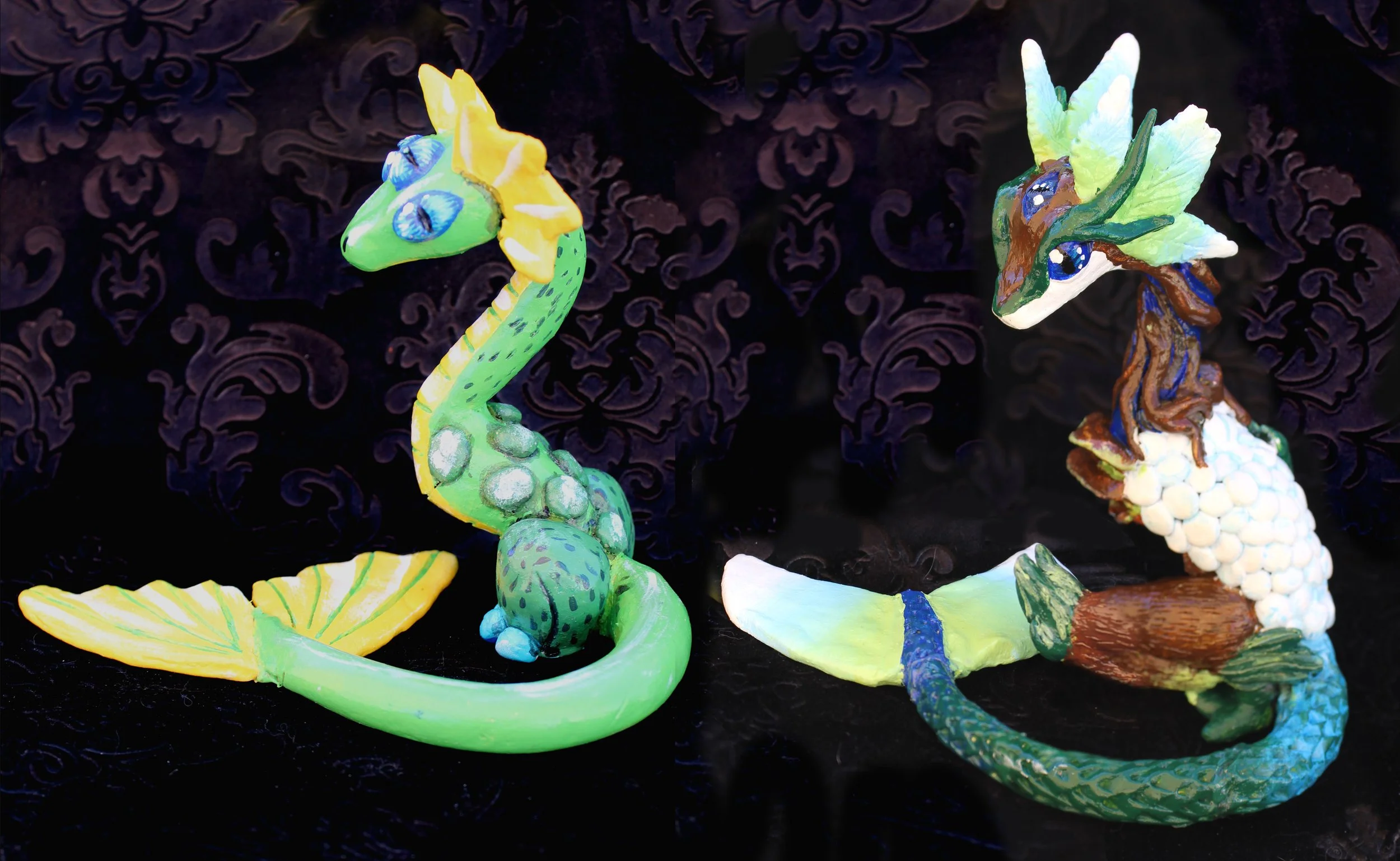 Colorful ceramic sculptures of a green chameleon with blue eyes and a yellow crest, and a multicolored dragon with green, blue, and brown accents, set against a dark background with decorative patterns.
