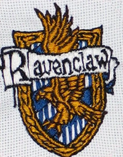 Embroidery patch with a shield, hands in a prayer position, and the word 'Ravenclaw' across the front.