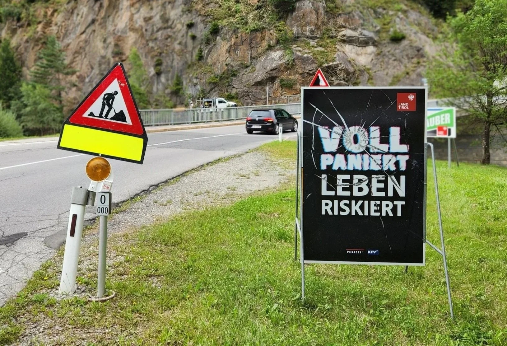 "Voll Paniert, Leben Riskiert" Plakat neben einer Landstraße in Tirol