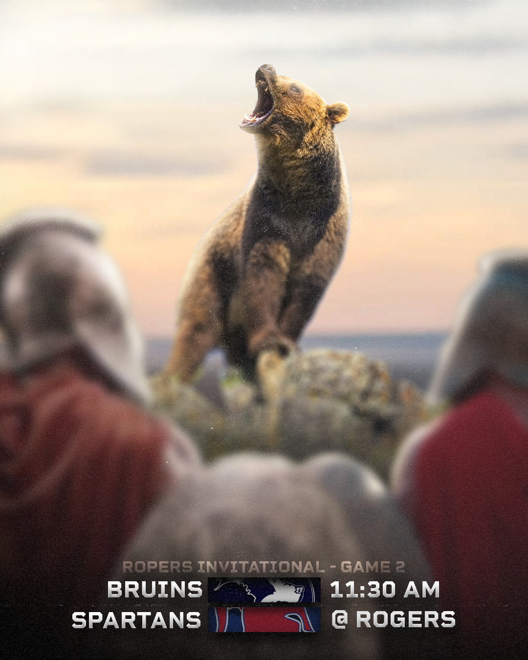 An aggressive-looking bear standing on rocks, roaring with mouth open, as if in a confrontation. The background has a soft, blurred sky. Text overlay announces a sports game between the Bruins and Spartans at 11:30 AM in the Ropers Invitational, Game