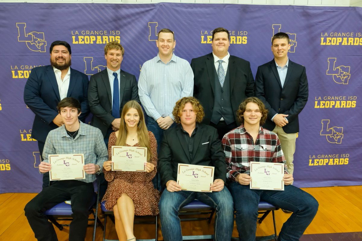 Group of students and teachers at an award ceremony for La Grange ISD Leopards, with some students holding certificates.