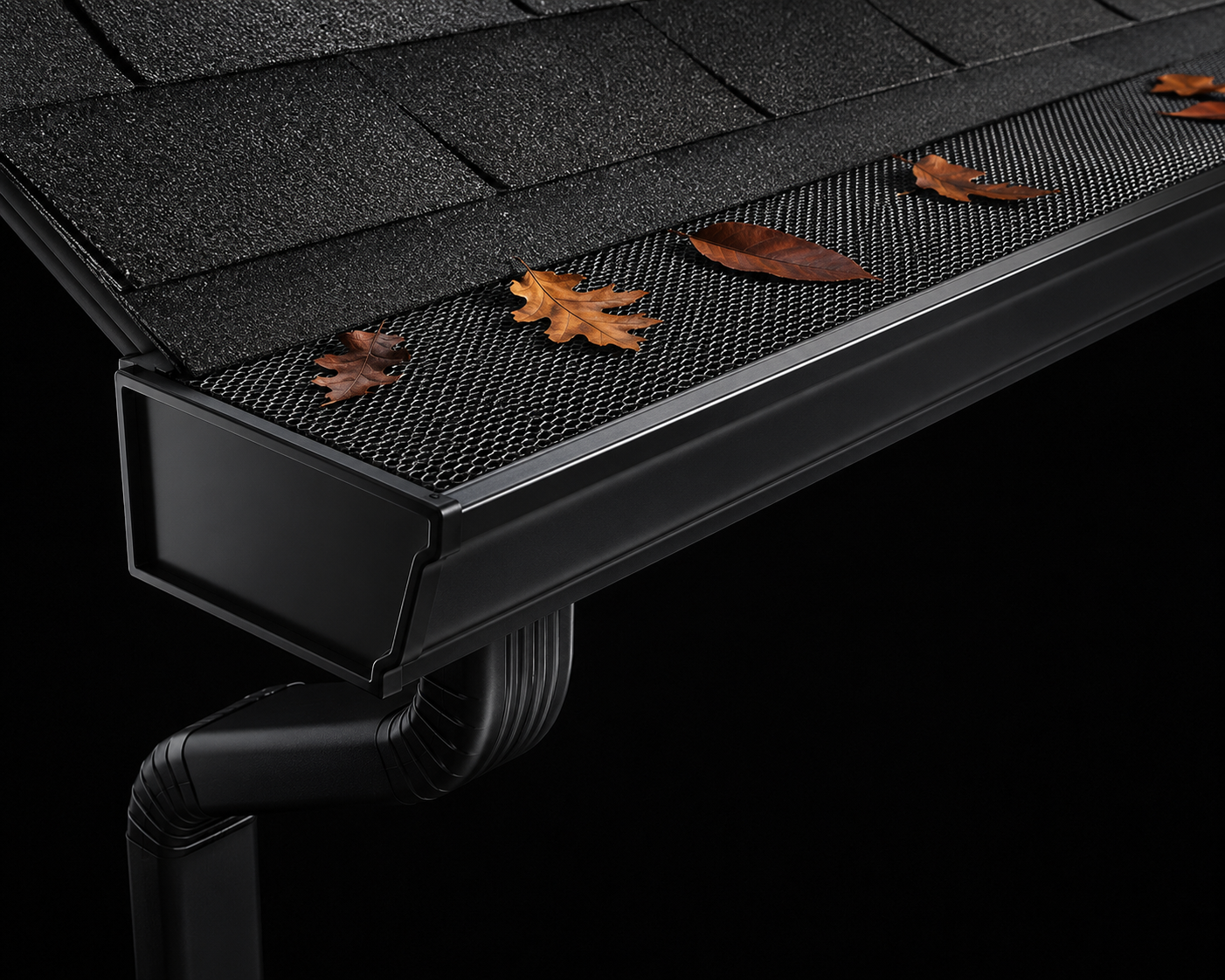 A black bench with a metal mesh surface, decorated with fallen brown leaves, against a dark background.