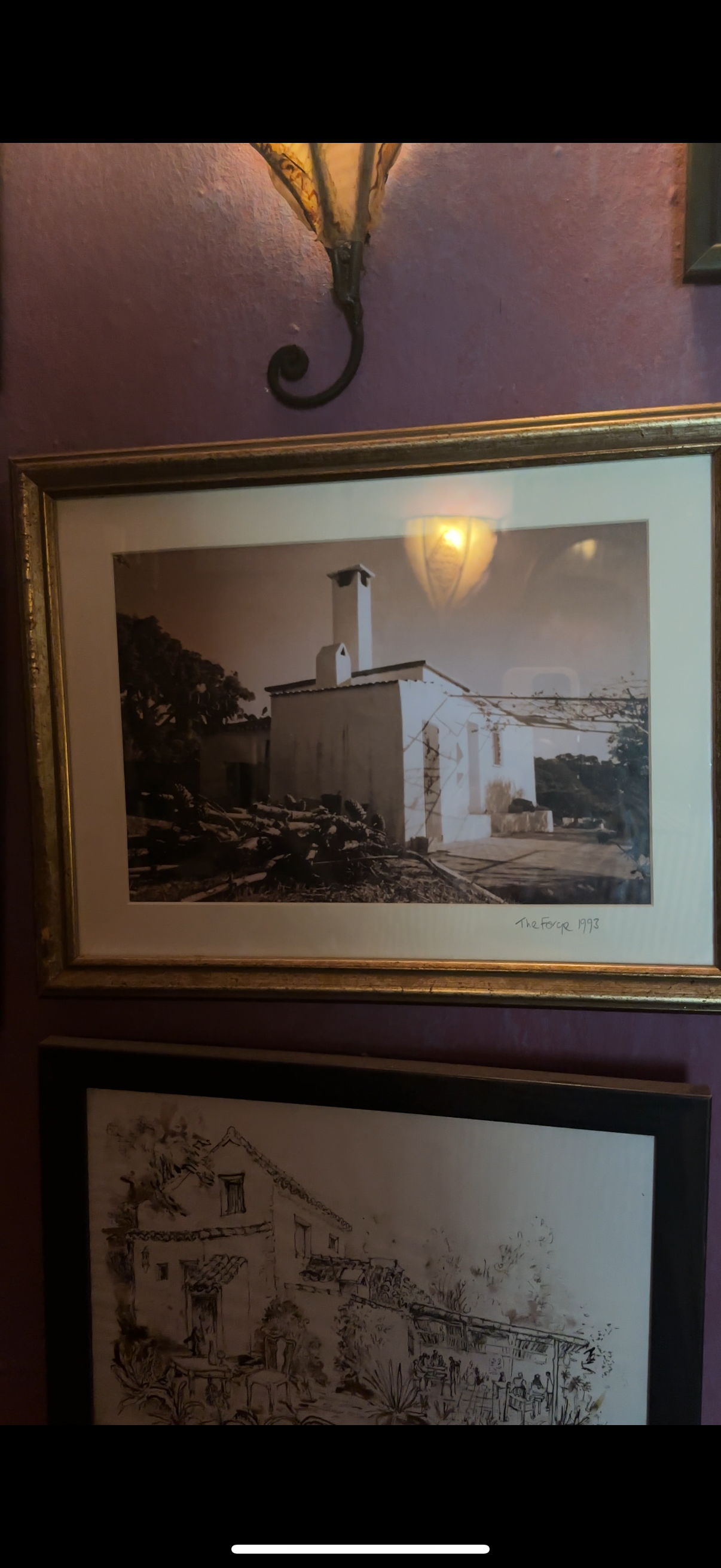 Photograph of a white house with a chimney, trees, and a clear sky, labeled 'The Forge 1993'.