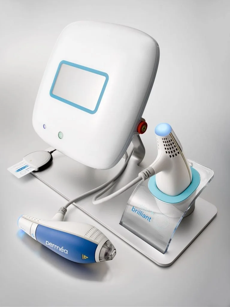 Medical device with a monitor, a handheld scanner labeled 'permea', and a probe labeled 'brilliant' on a white surface.