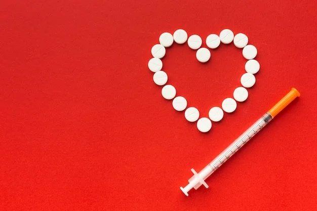 White pills arranged in the shape of a heart on a red background with a syringe nearby.