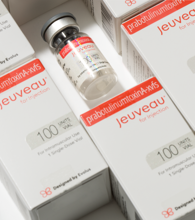 Vials of Jeuveau, a type of botulinum toxin for injection, displayed with their packaging, indicating 100 units per vial.