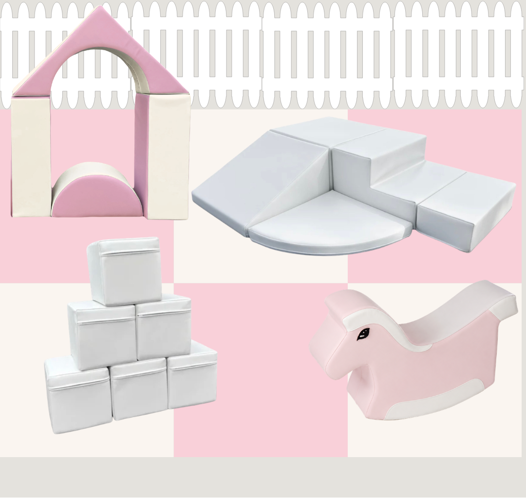Soft, pastel-colored foam and fabric children’s play furniture in pink and white, including a house-shaped piece, a slide, a cube stack, and a rocking horse.