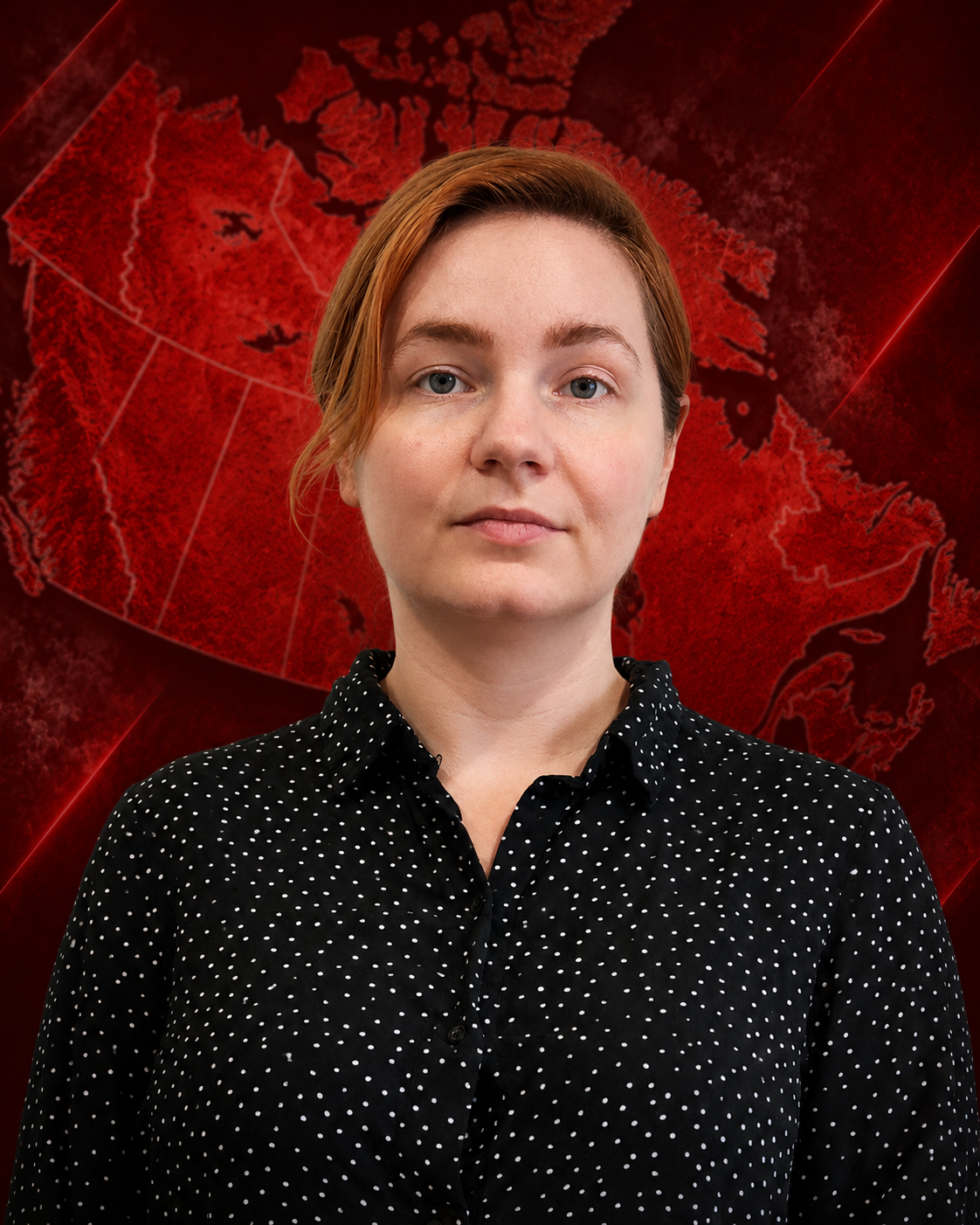 A woman with short red hair, blue eyes, wearing a black shirt with white polka dots, standing against a plain light-colored background.