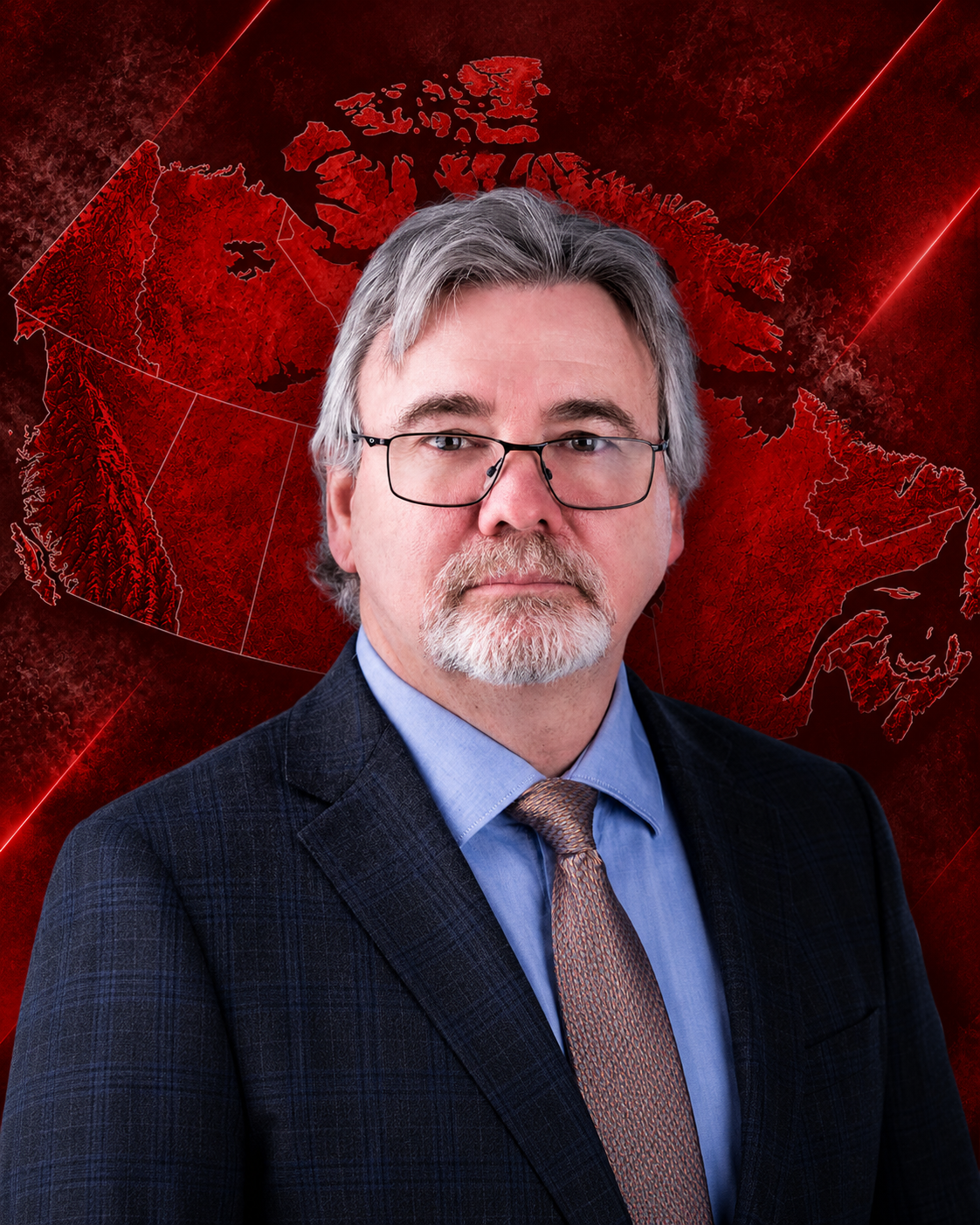 A smiling middle-aged man with gray hair, beard, and glasses, wearing a dark suit, light blue shirt, and patterned tie, against a white background.