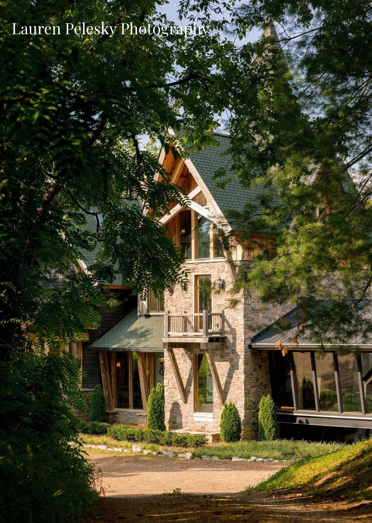 An unconventional wedding venue appears through the trees at an AirBnB wedding in Franklin, Tennessee.