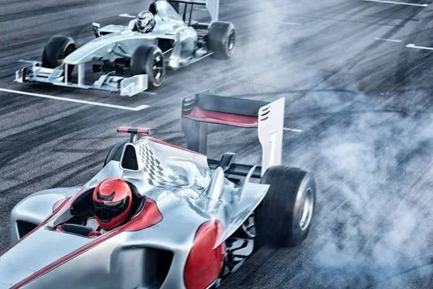 Two race cars on a track, with the car in the foreground spinning and producing smoke, while the car in the background is moving forward.
