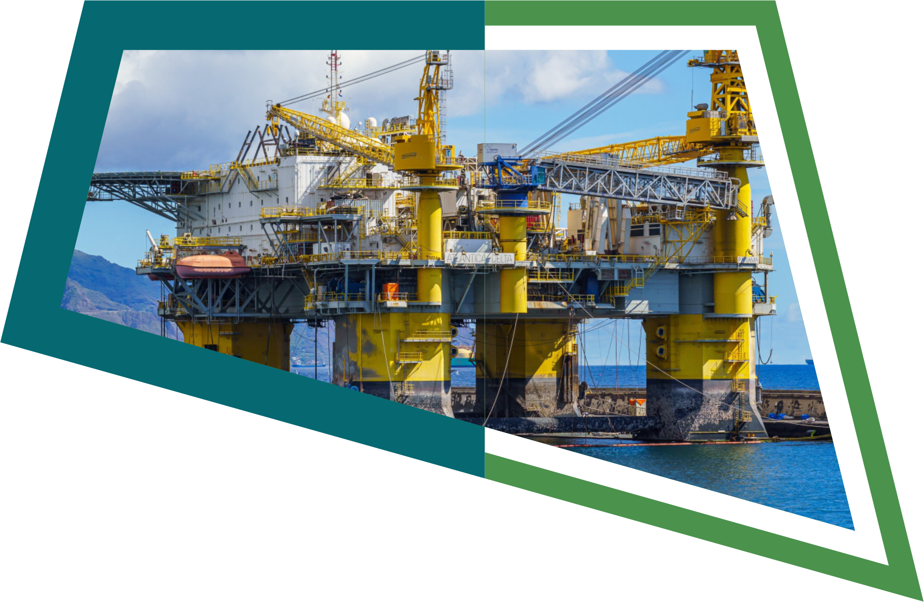 An offshore oil drilling platform in the water with mountains and a cloudy sky in the background.