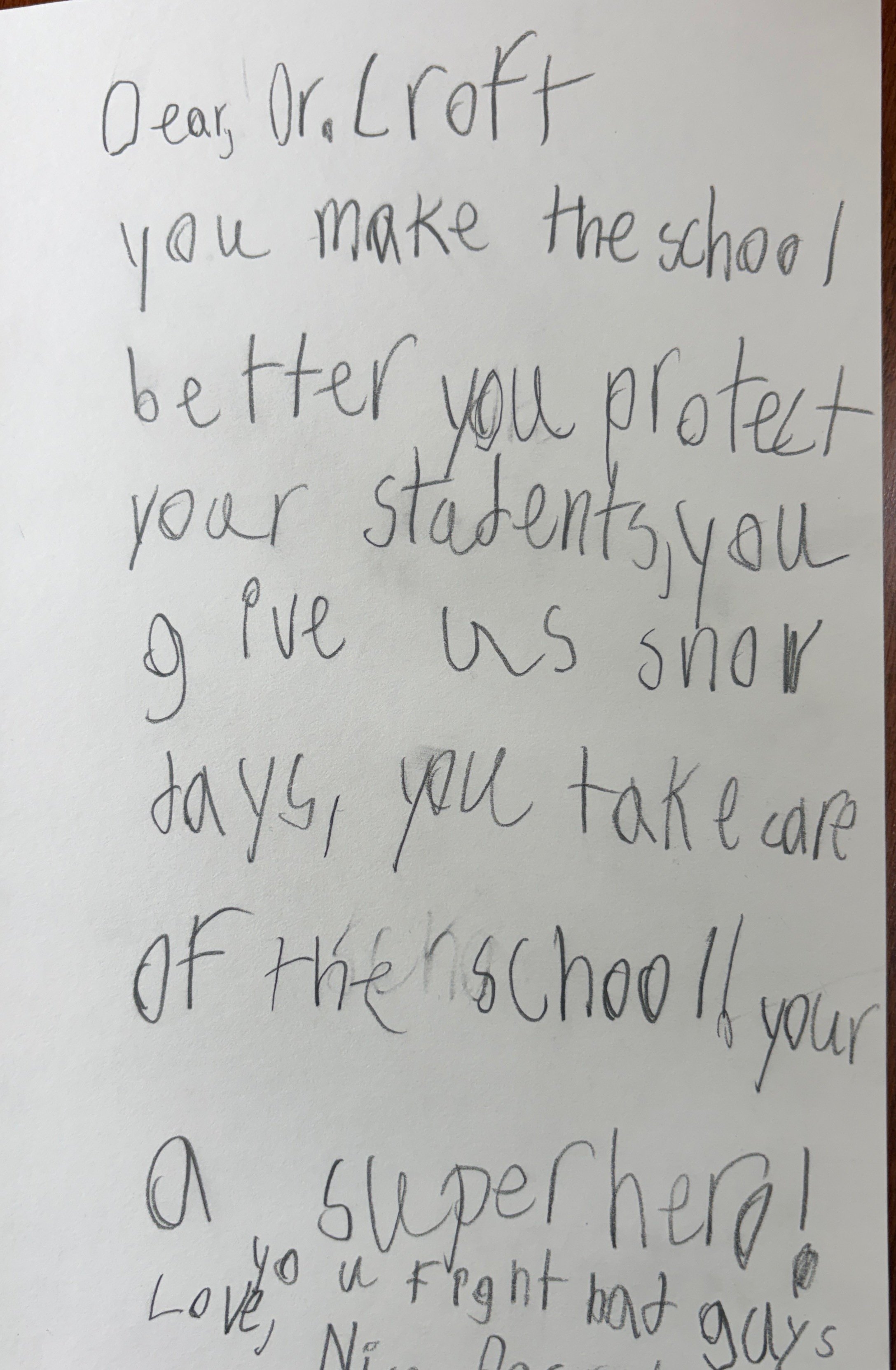 Handwritten letter addressed to Dr. Crott with messages about making the school better, protecting students, and celebrating a super hero.