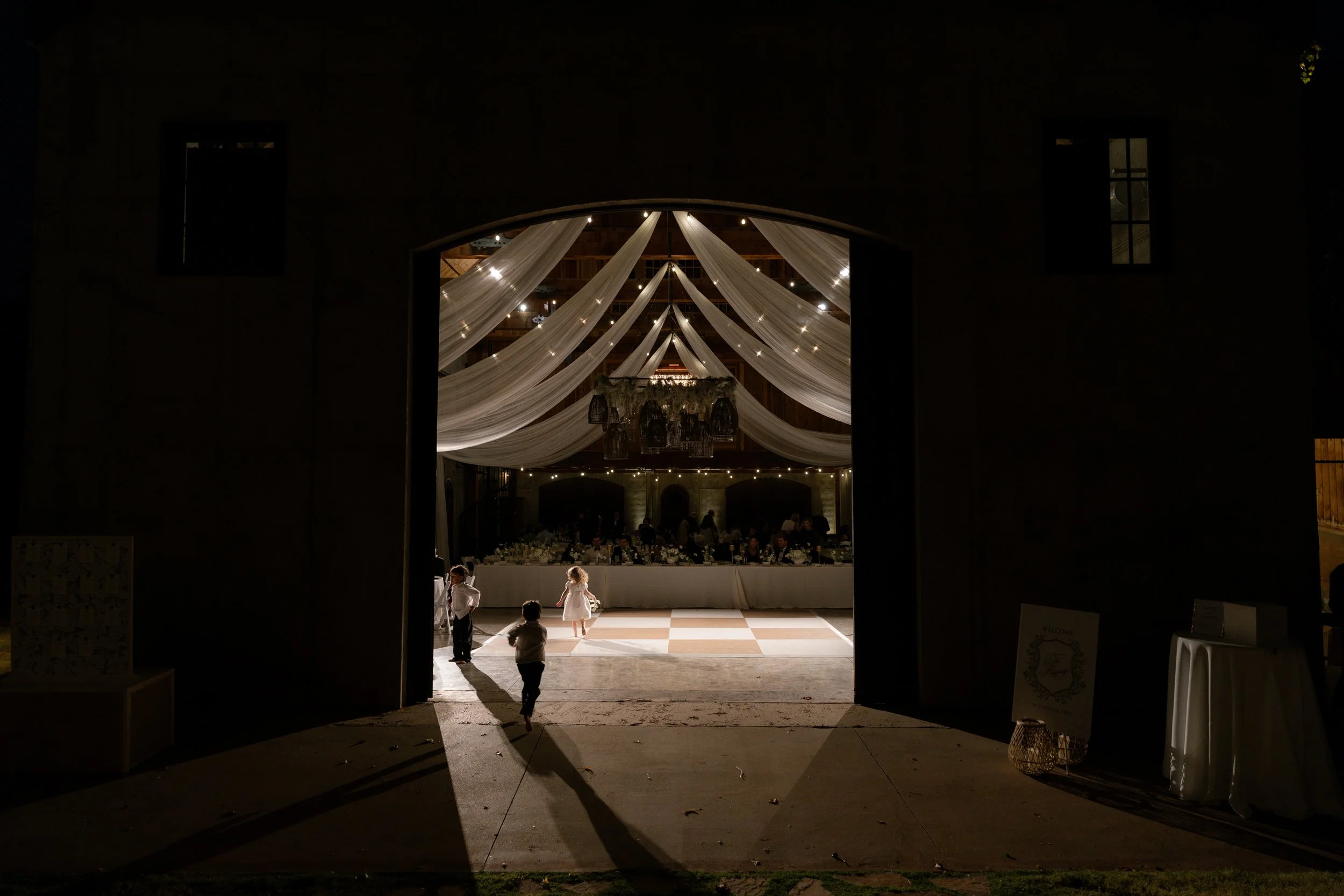 Dramatic image of wedding reception venue with small children running