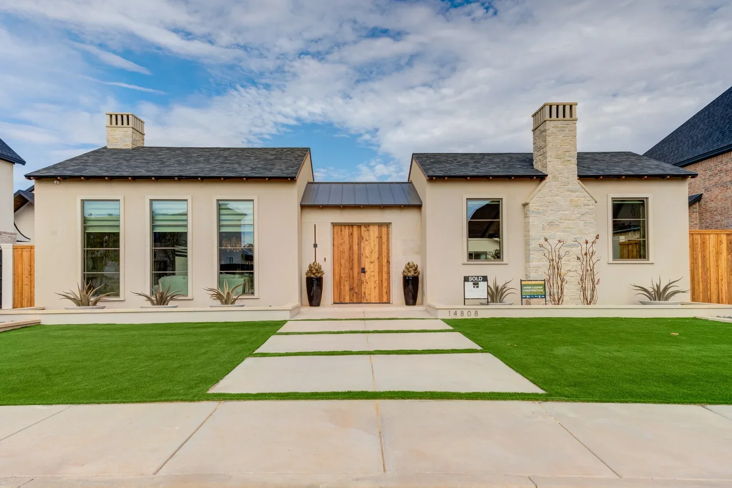 Home with stone and stucco details and a double-door entry.