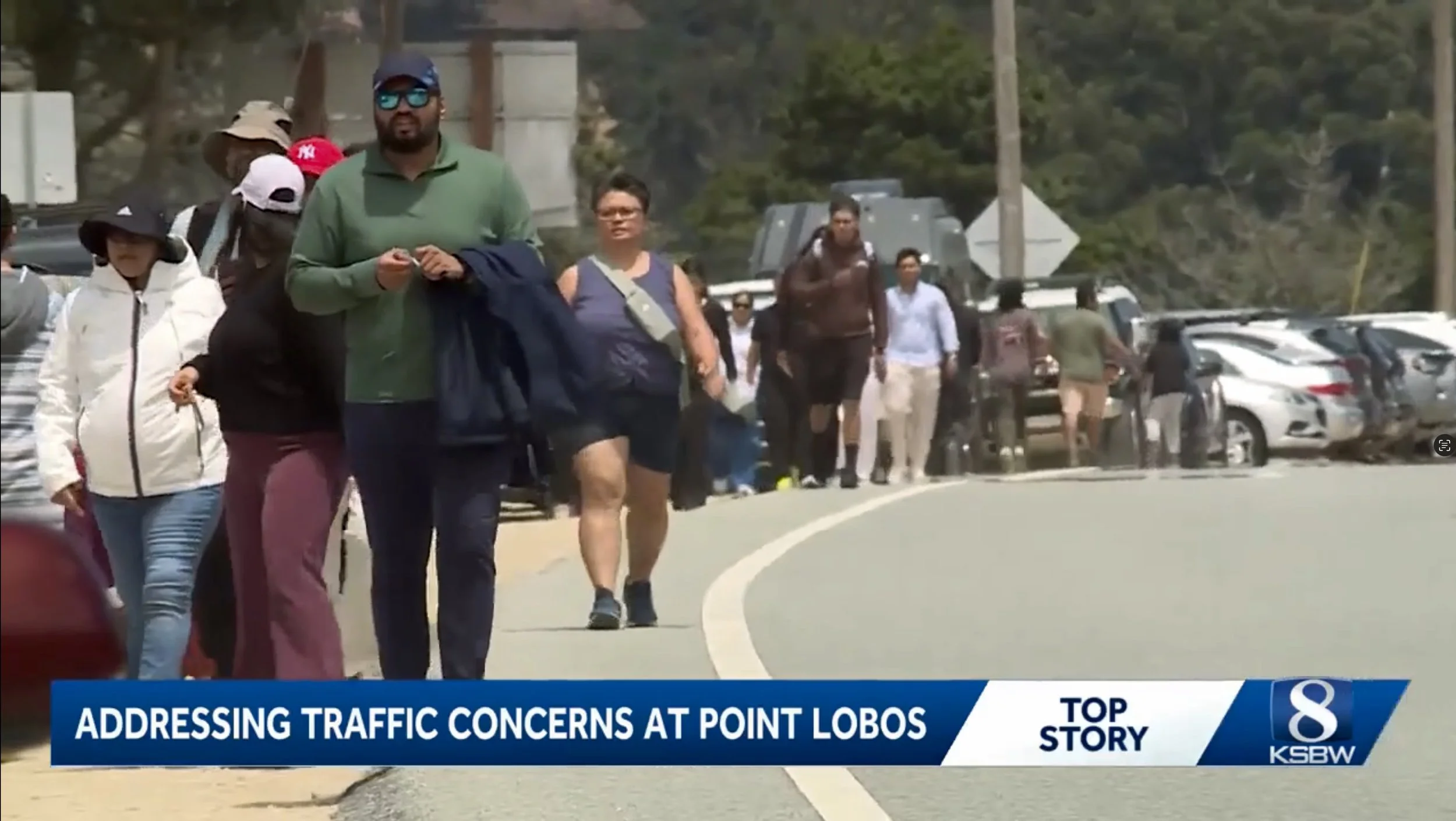 Throngs of visitors walk along Highway 1 to reach Point Lobos State Natural Reserve
