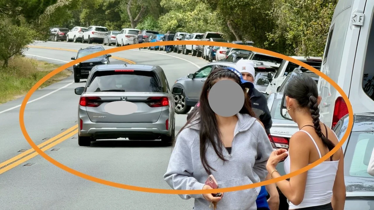 Pedestrians must try to avoid cars backing into parking spaces on the narrow should of Highway 1.