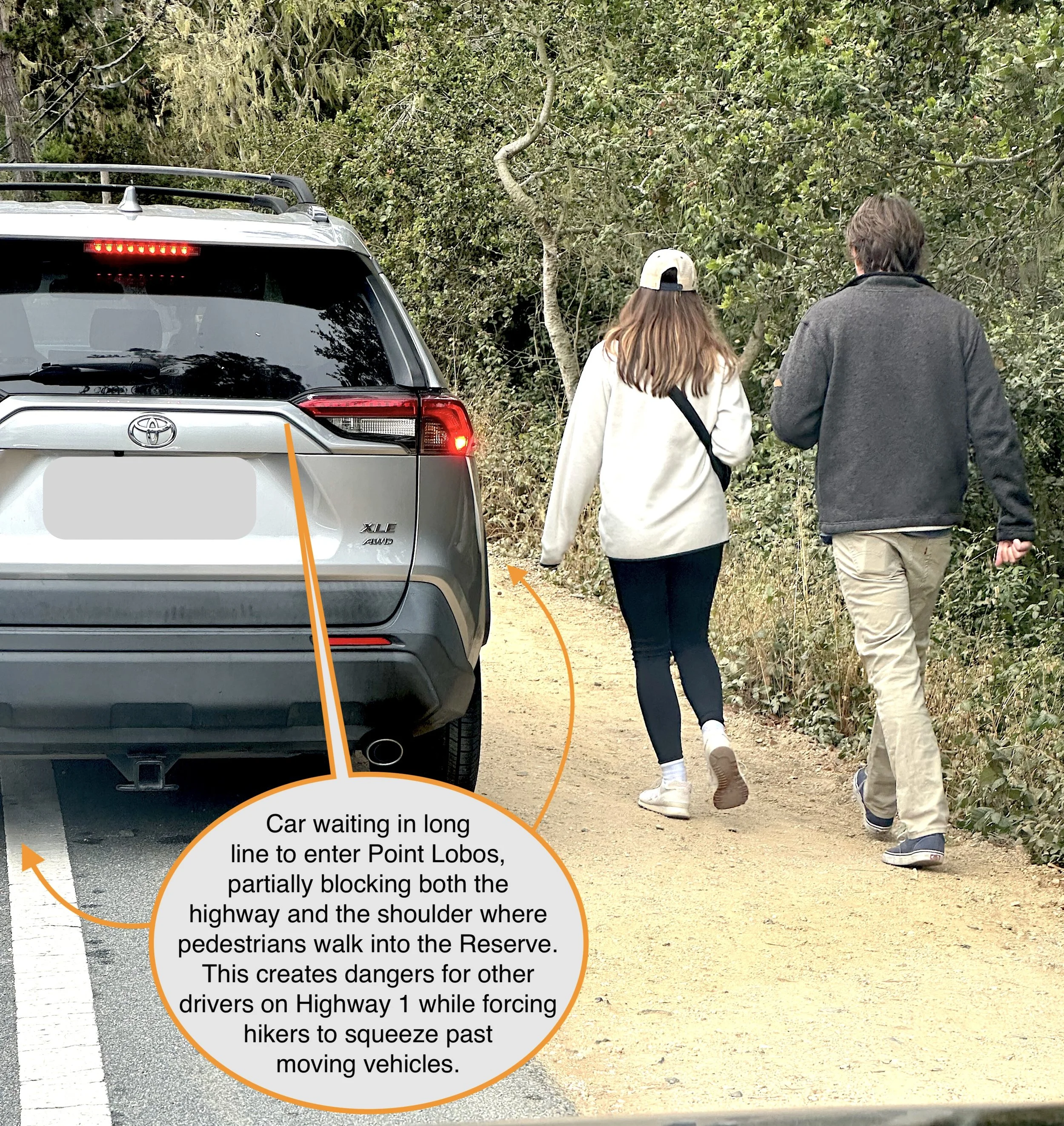 Pedestrians on a narrow highway shoulder near the entrance to Point Lobos who are in danger of being struck by vehicles.
