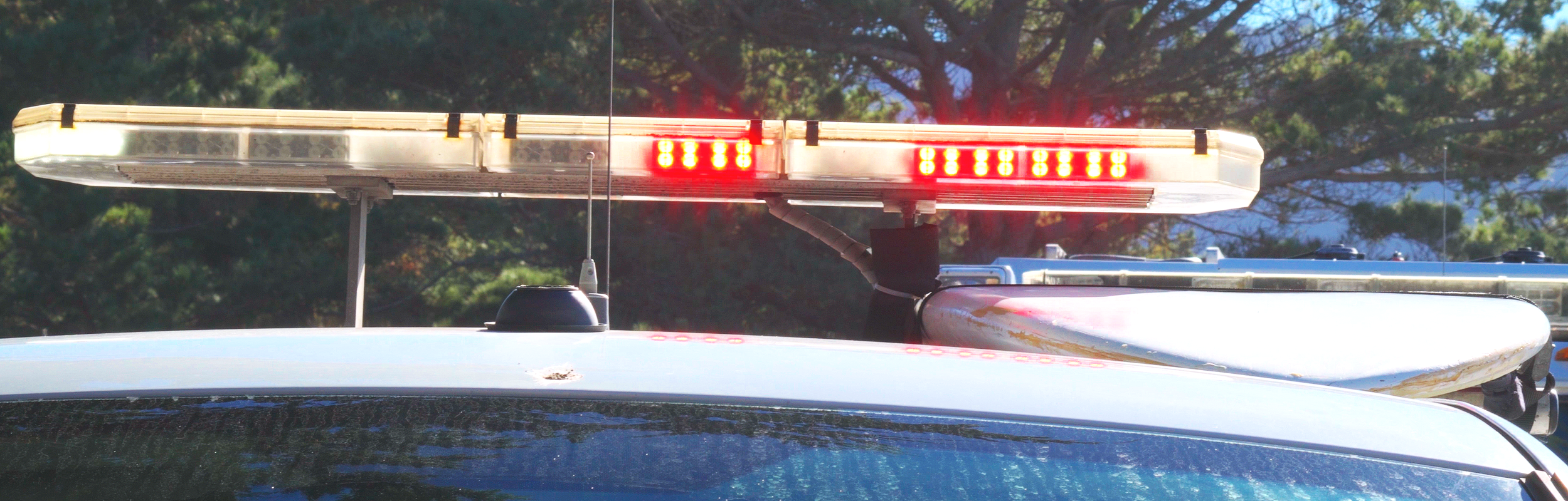 The lightbar of a State Parks peace officer vehiicle flashes red and white.