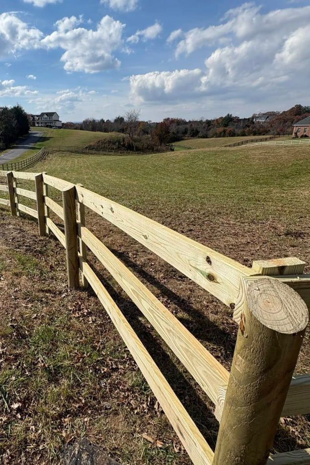 Custom wooden privacy fence installation on sloped terrain in East TN. Lane's Fence provides expert construction, premium materials, and level fence lines for secure residential boundaries.