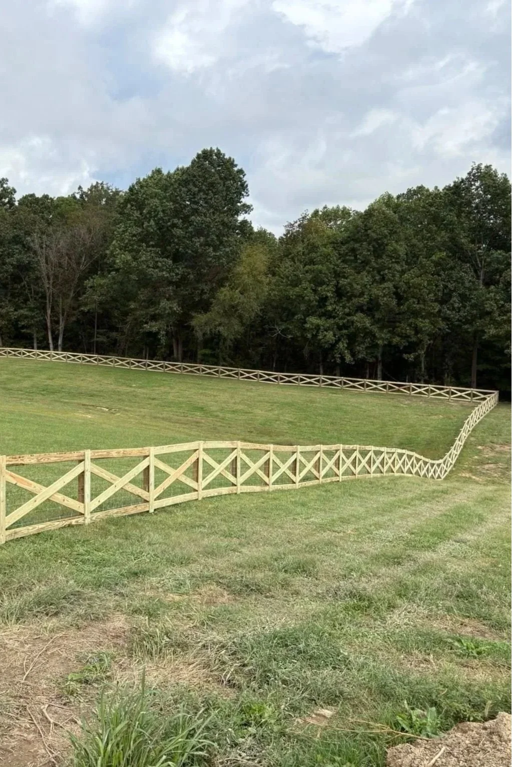 Custom wooden privacy fence stepping down a sloped residential yard in East TN, installed by professional fence builders at Lane's Fence.