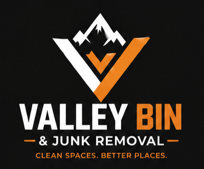 Valley Bin & Junk Removal logo with white mountain, orange checkmark, black background, and tagline 'Clean Spaces. Better Places.'