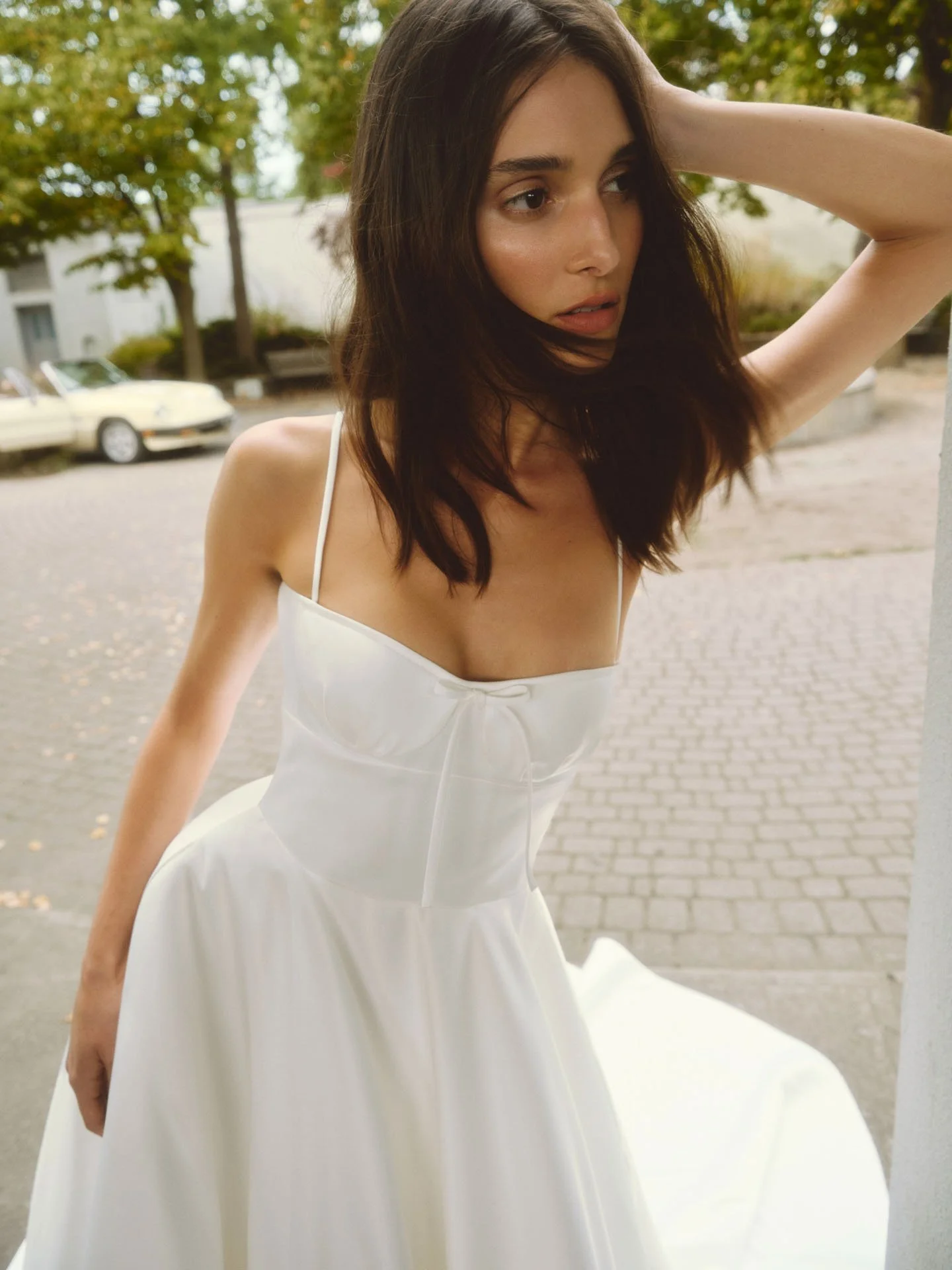 Model wearing strapless Alyne dress, outside. 