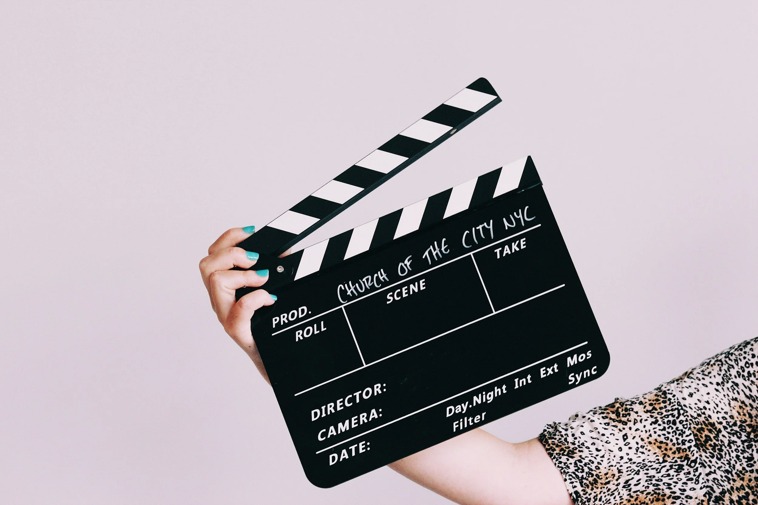 momager holding clapperboard for child performer