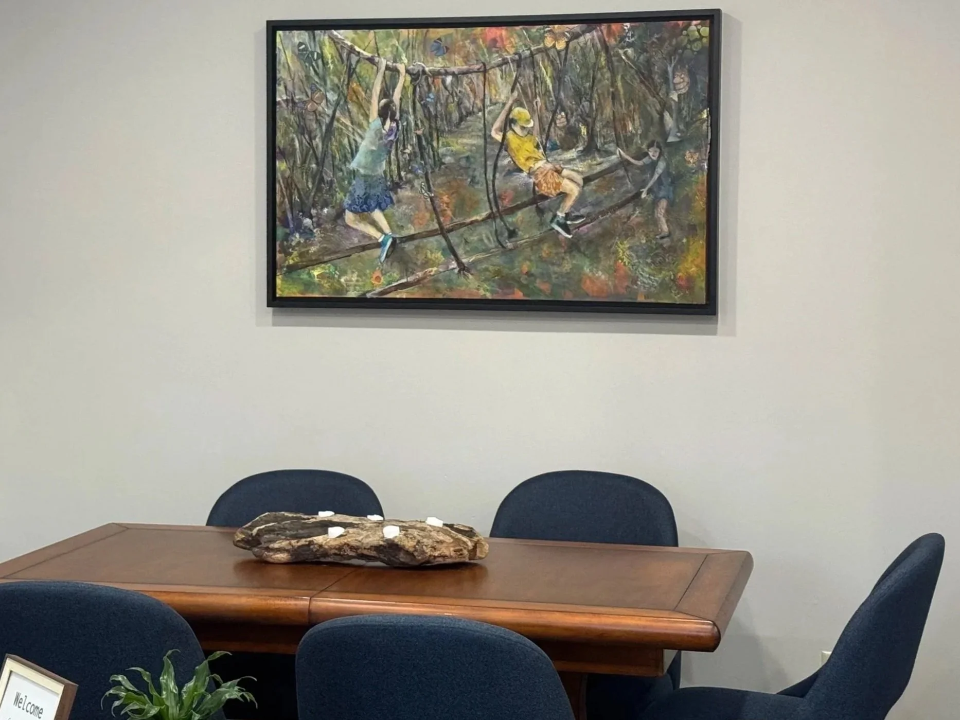 The AHead Wellness office waiting room showing the table and art on the wall.