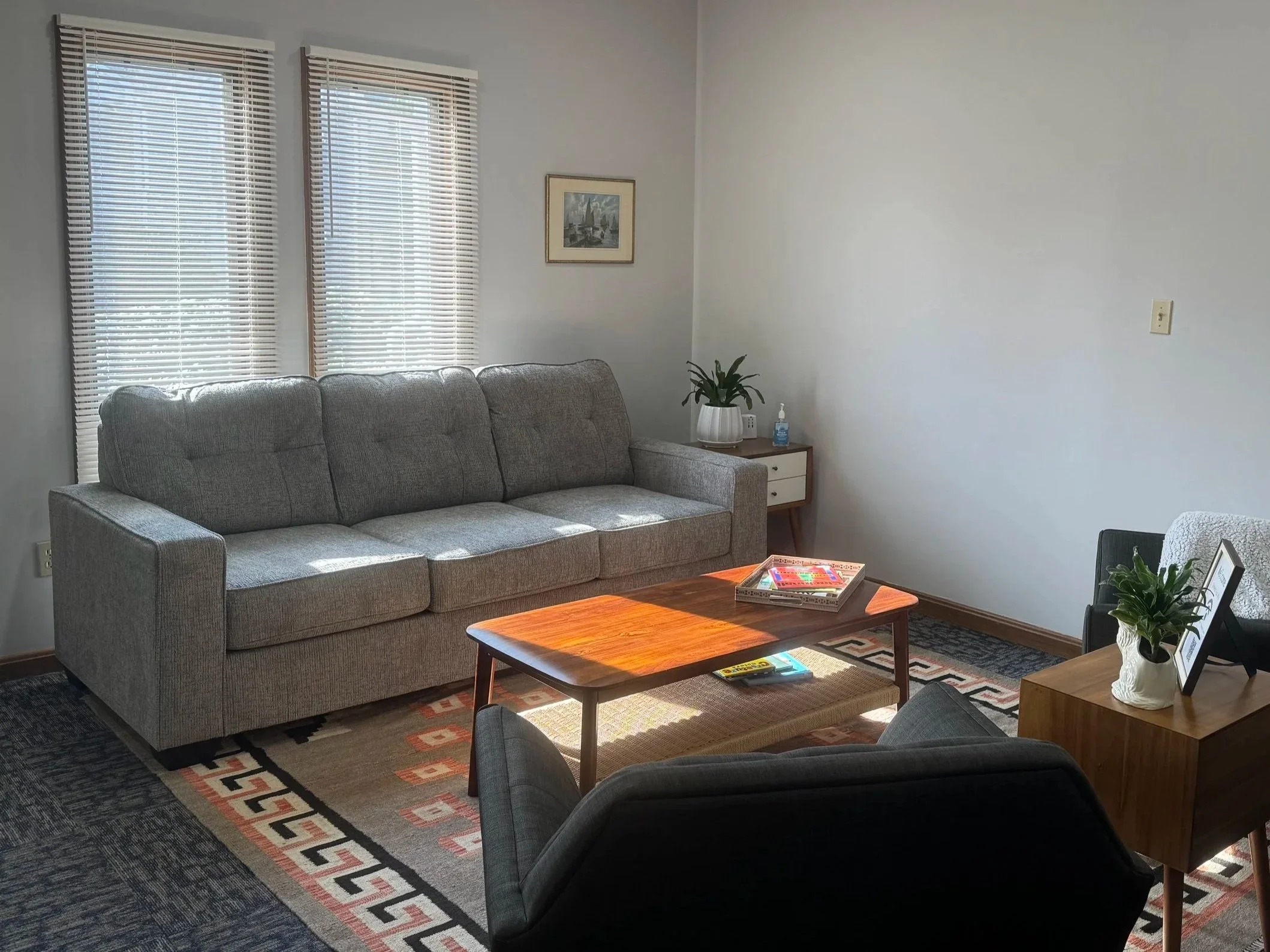 The AHead Wellness waiting room couch, table, and chairs. The space is cozy and comfortable.