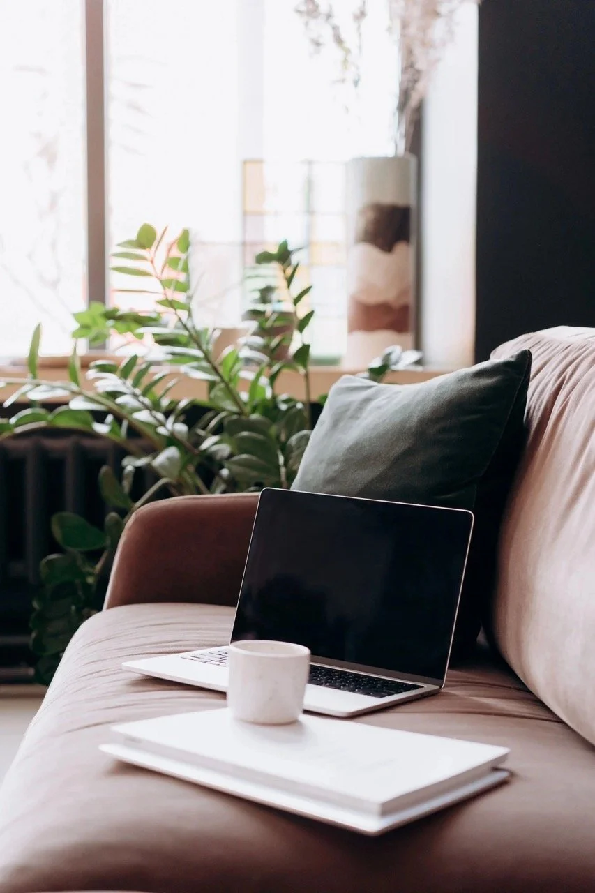 Laptop and coffee on a chair in a calm home setting for virtual therapy