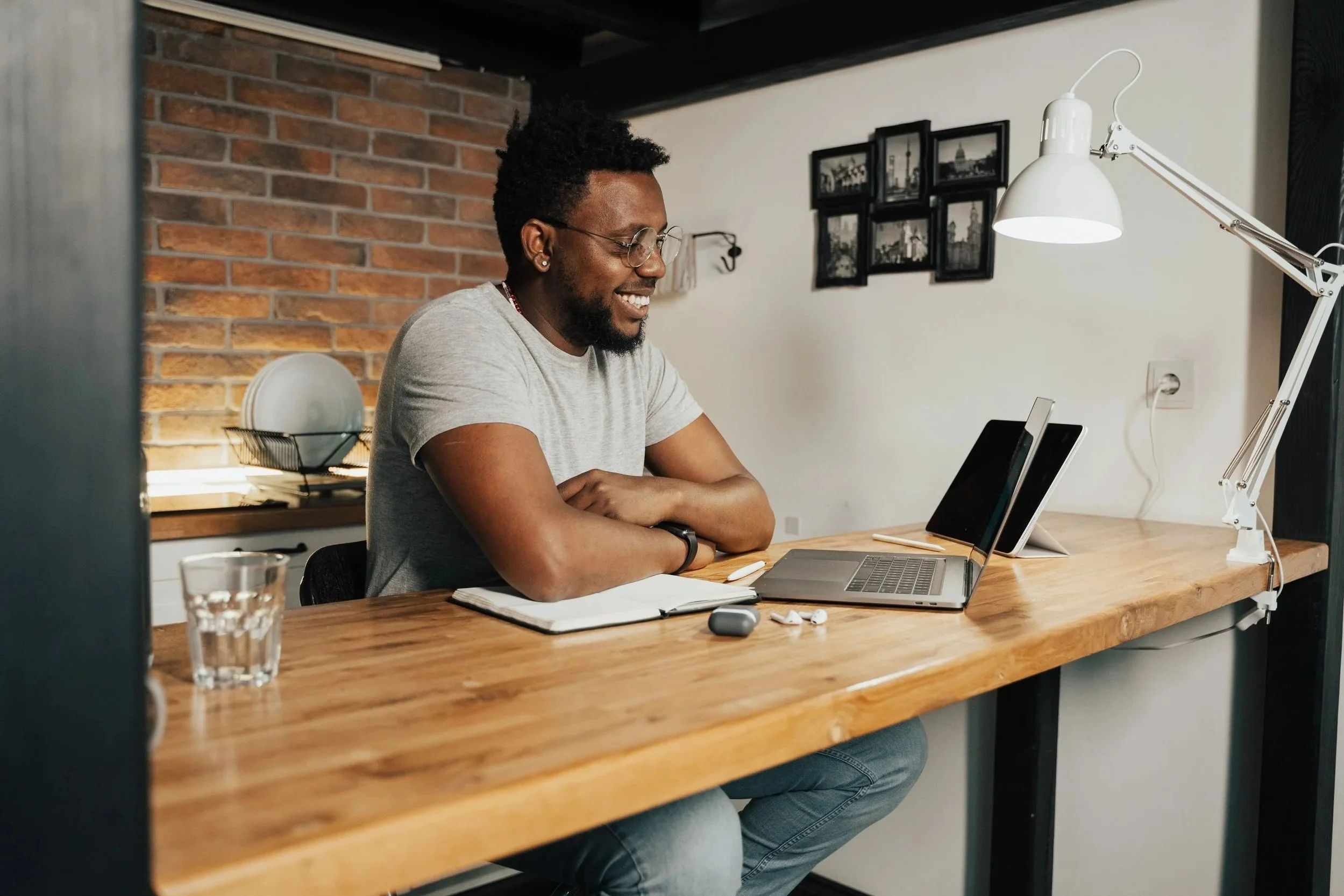 Man working from a warm home office setup, reflecting flexible virtual therapy sessions