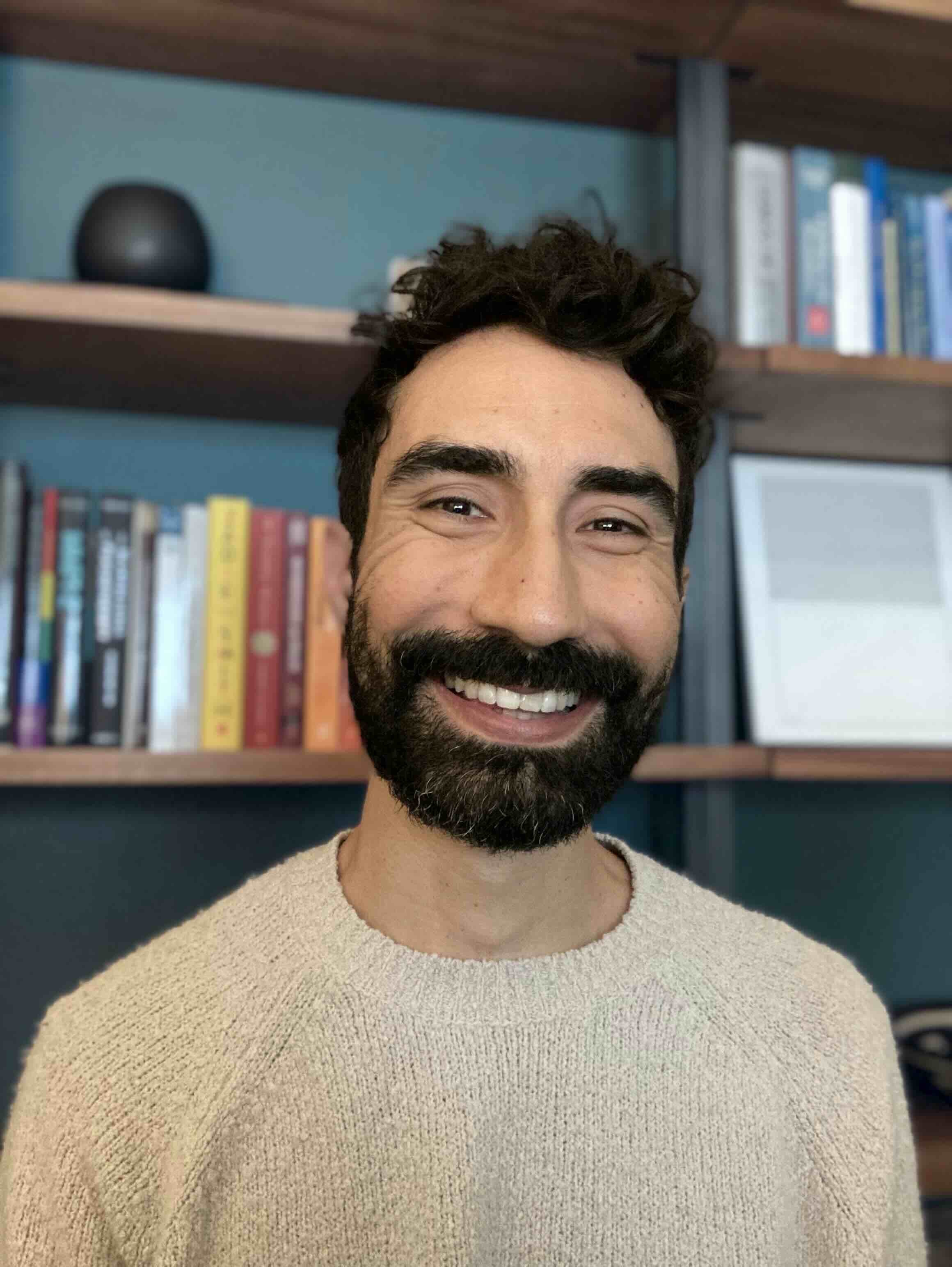 Michael Olivares PhD in office. Bookshelf in background.