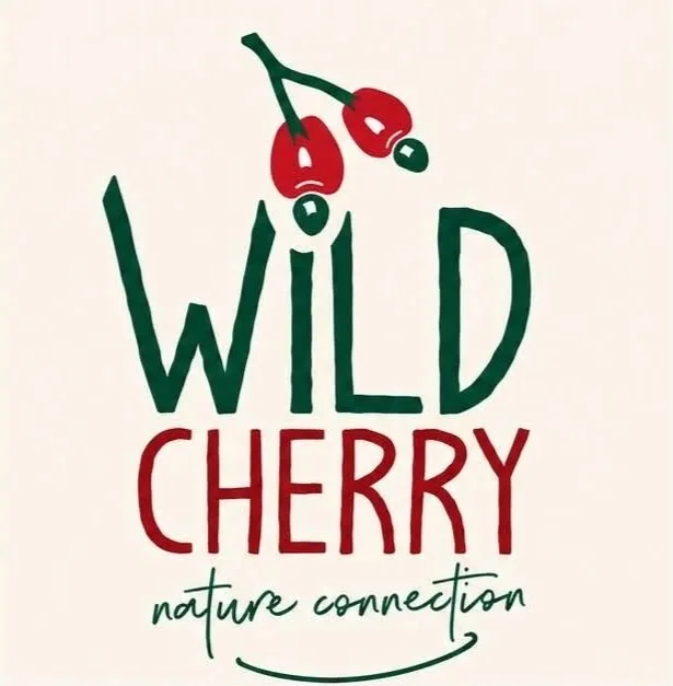 Illustration of two wild cherries with green stems and red fruit, with the words 'WILD CHERRY' and 'nature connection' written below. WILD CHERRY nature connection logo.