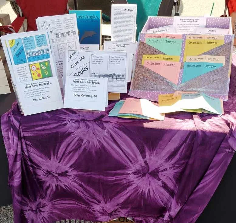 Photo of my writing products at the farmer's market.