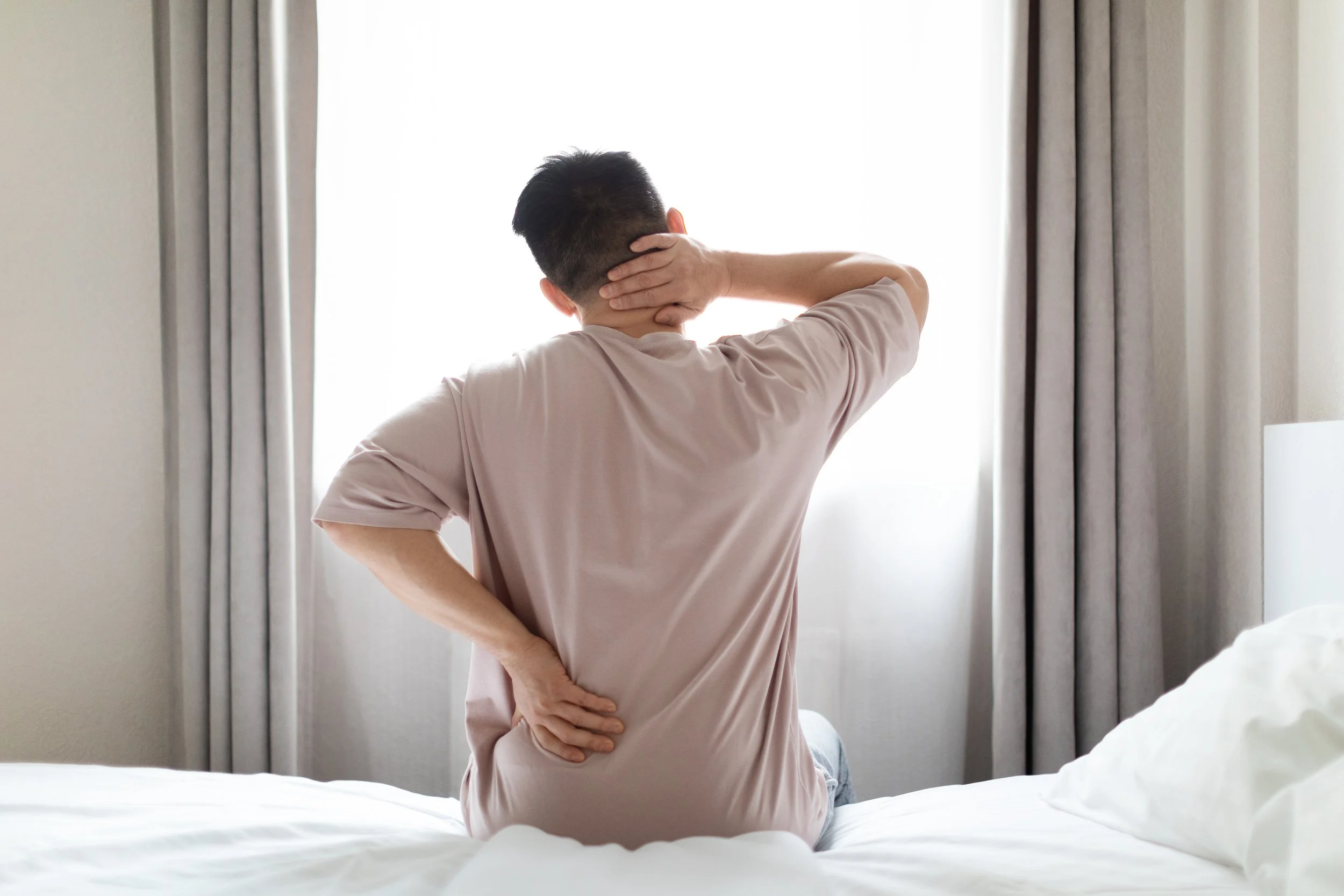 Person experiencing back and neck pain