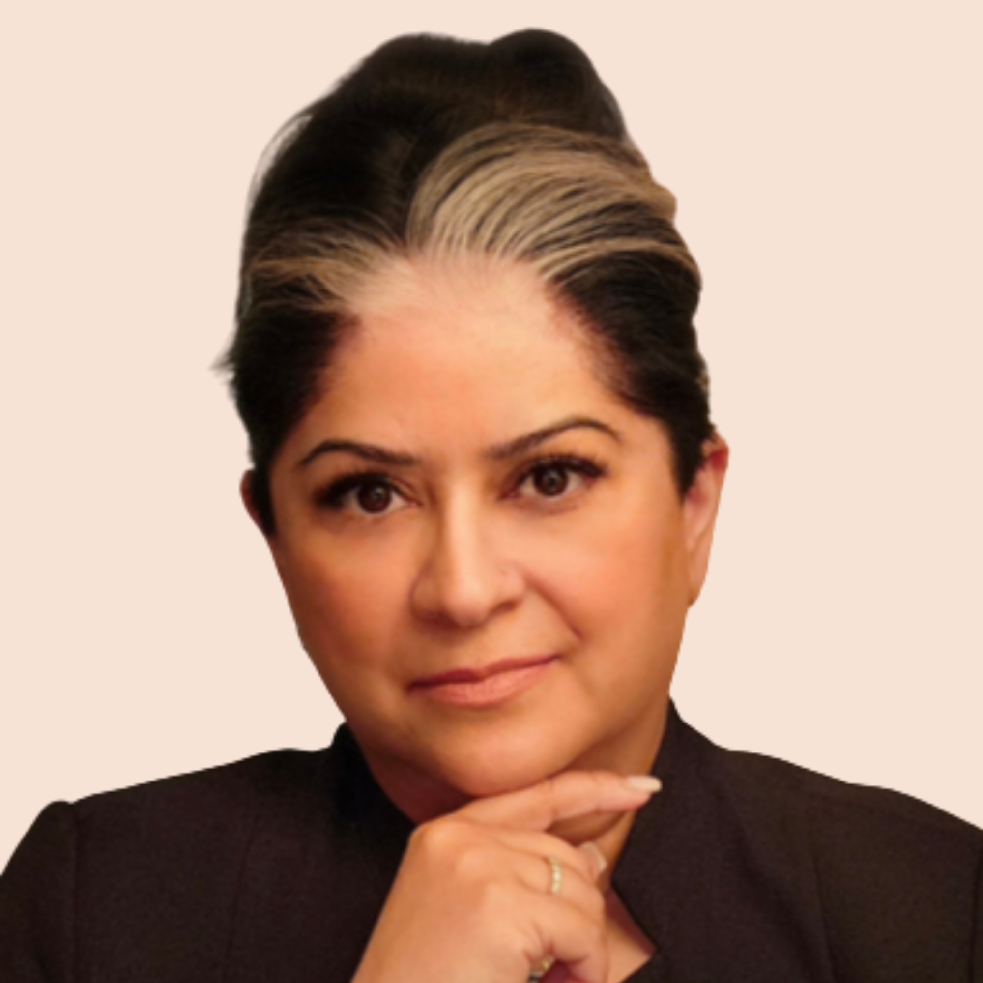 A woman with short dark hair styled in a sleek updo with lighter highlights, wearing a black top, with a neutral beige background.