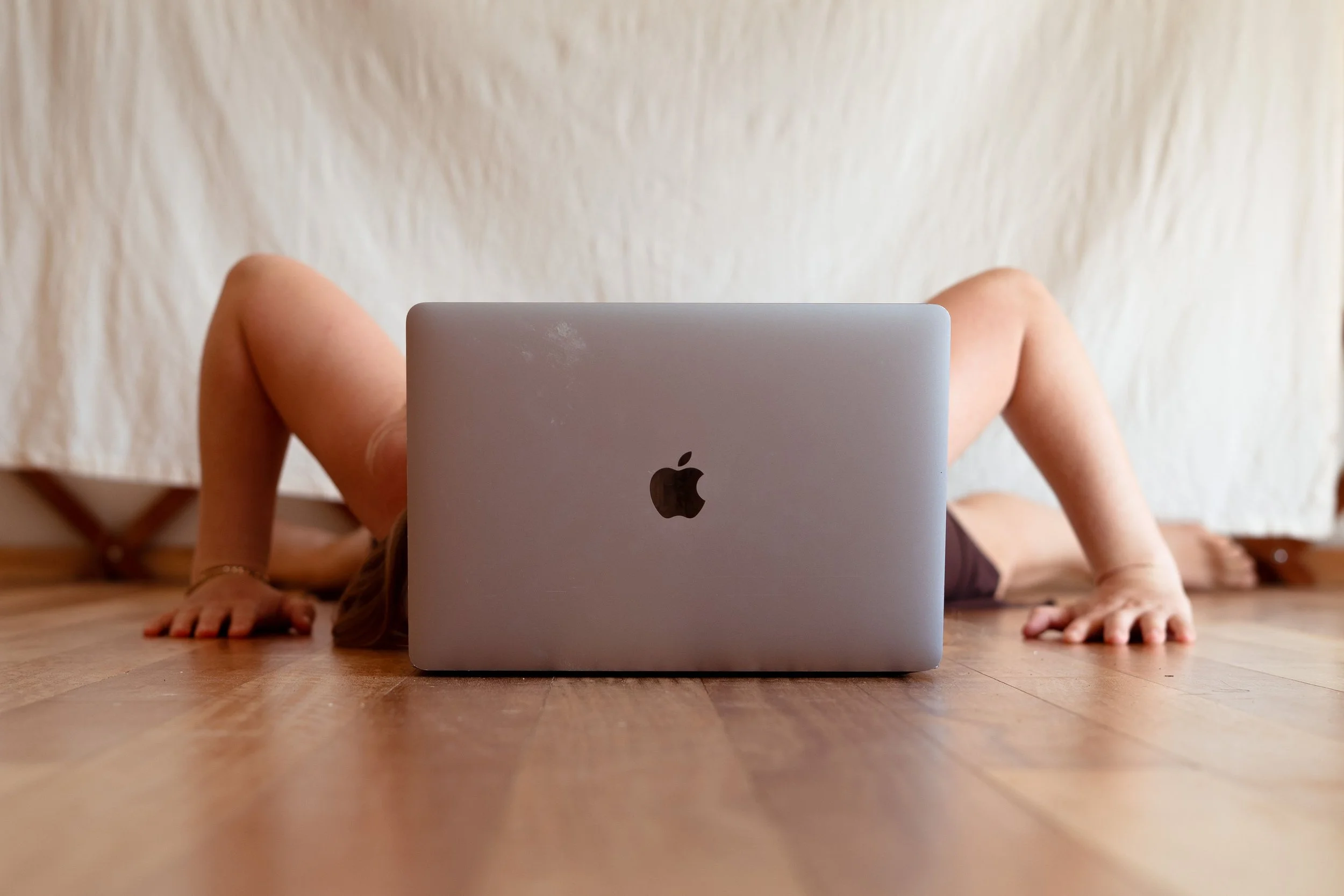 Image of a woman behind a laptop, idea being being the brains behind the organisation, use technology to amplify your digital presence with luminera