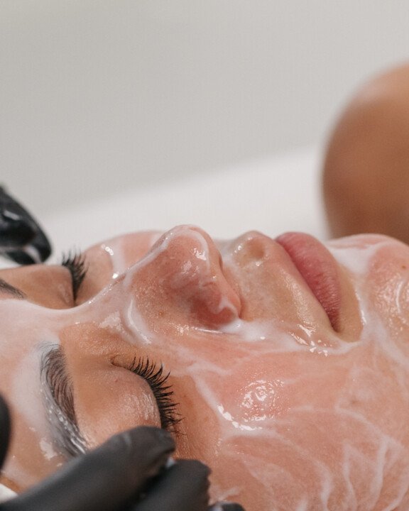 Close-up of a woman receiving a facial treatment, with the oxygen rx in action.