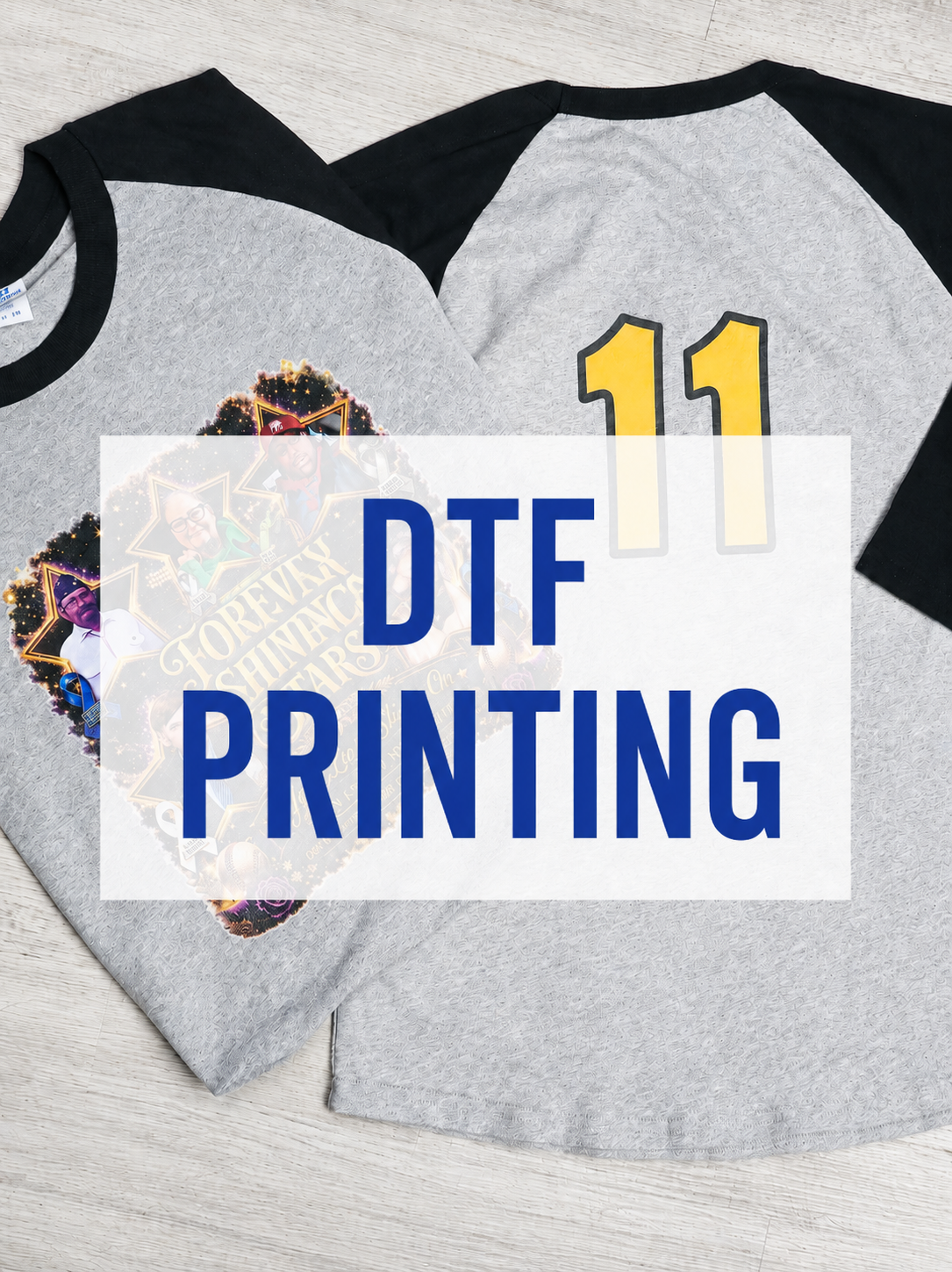 Gray and black sports jerseys, one with a number 11 and the other with a graphic of characters and stars, placed on a wooden surface with a white overlay displaying the text 'DTF PRINTING'.