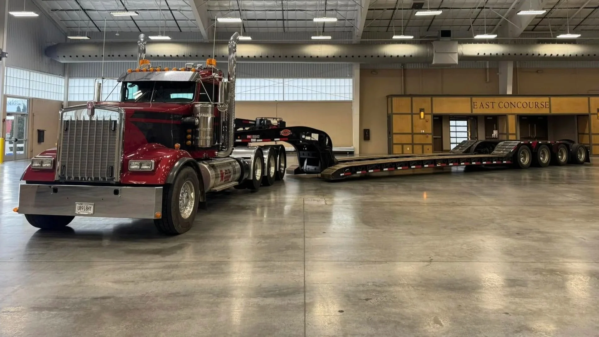 Red King’s Kid Express truck and lowboy trailer inside a workshop.