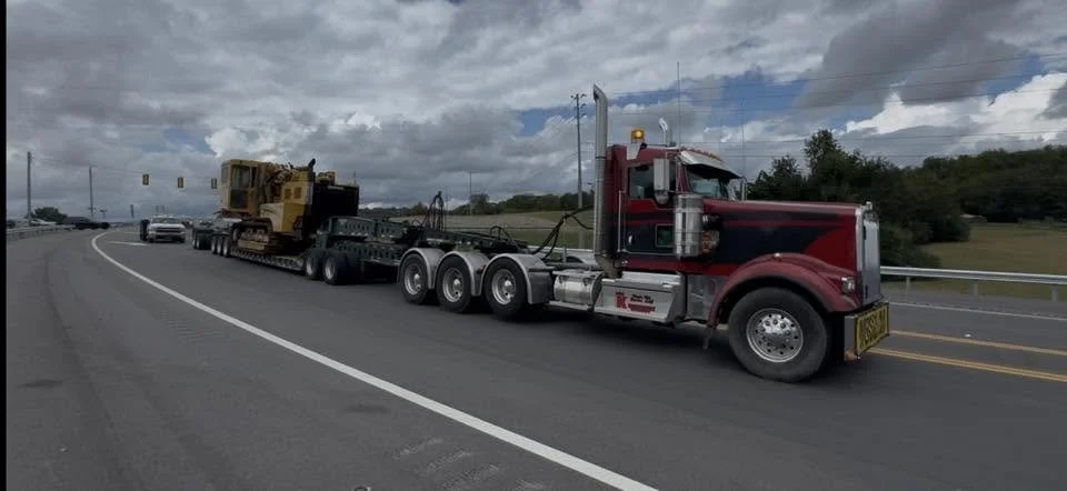 Red King’s Kid Express truck transporting construction equipment.