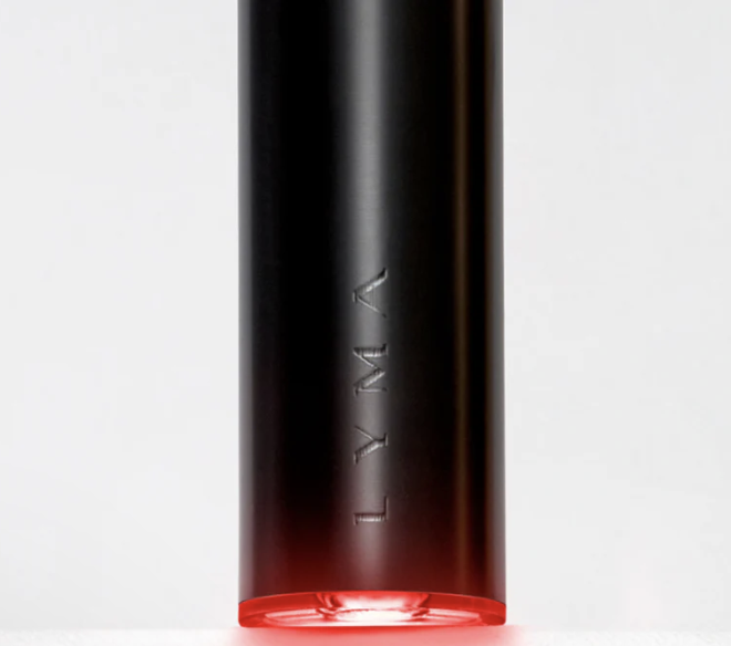 Close-up of a black cylindrical device with the word 'TMY' etched on it and a red light at the bottom.
