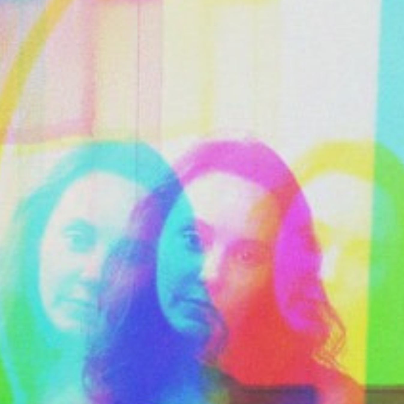 Blurred, colorful image with overlapping circles and two partially visible faces.