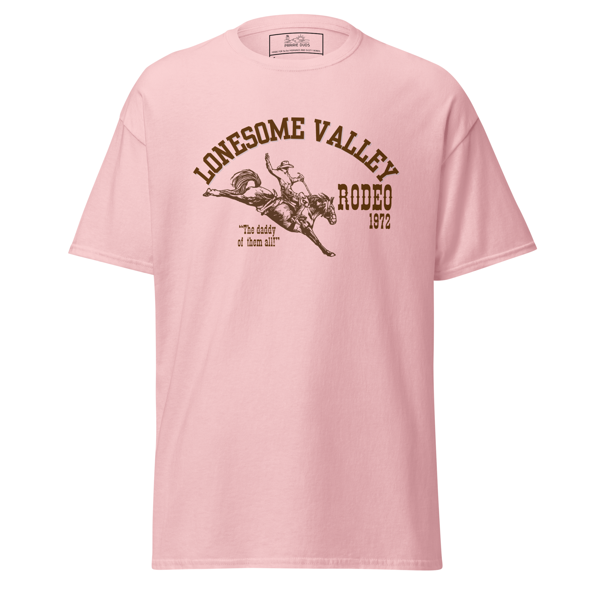 Pink T-shirt with a graphic design of a rodeo rider and horse, with text that says "Lonesome Valley Rodeo 1972" and a quote below that says "The daddy of them all".