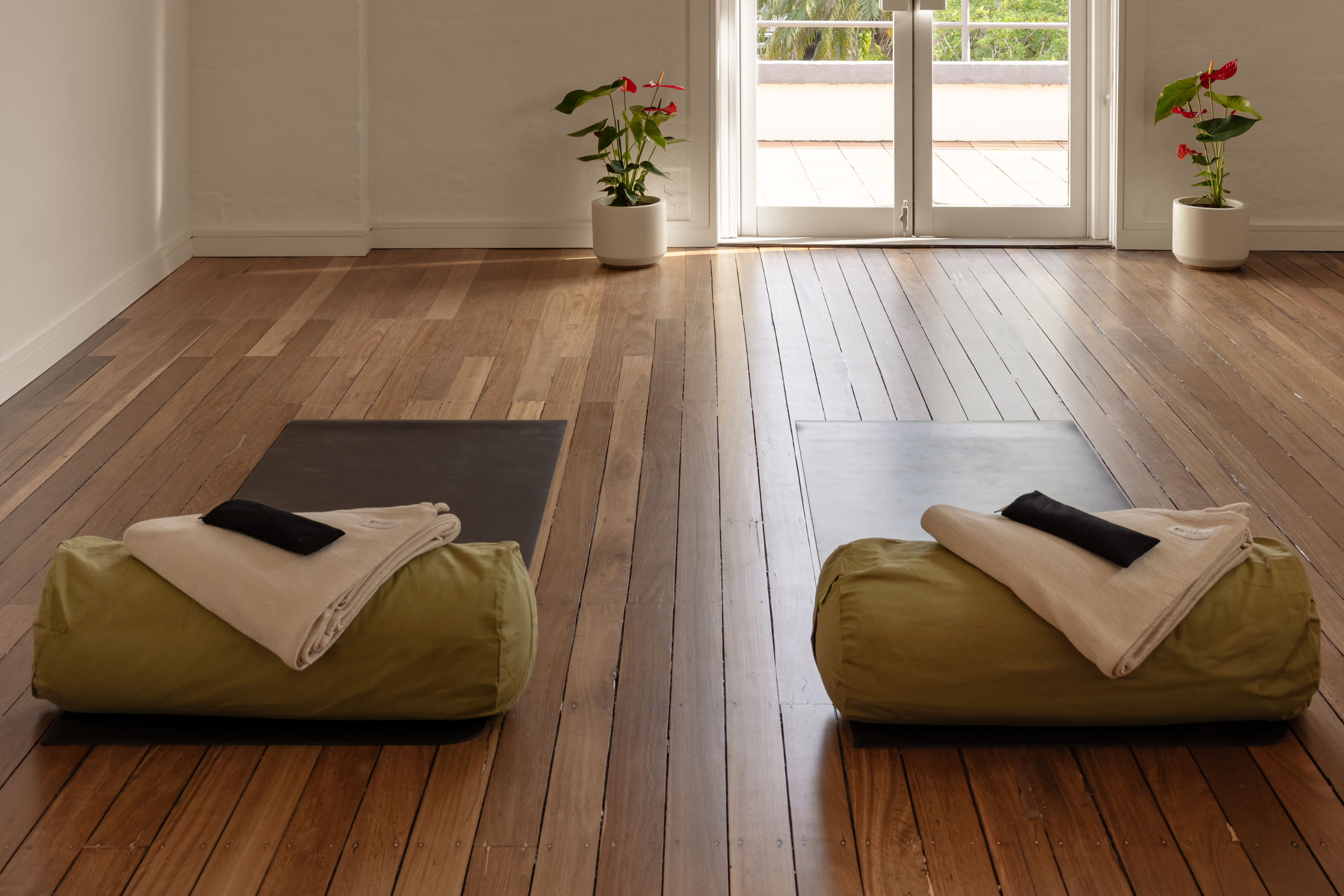 Warm natural light flowing across the timber floors of Flow Republic's purpose-designed yoga studio, creating a calm and welcoming space for practice.