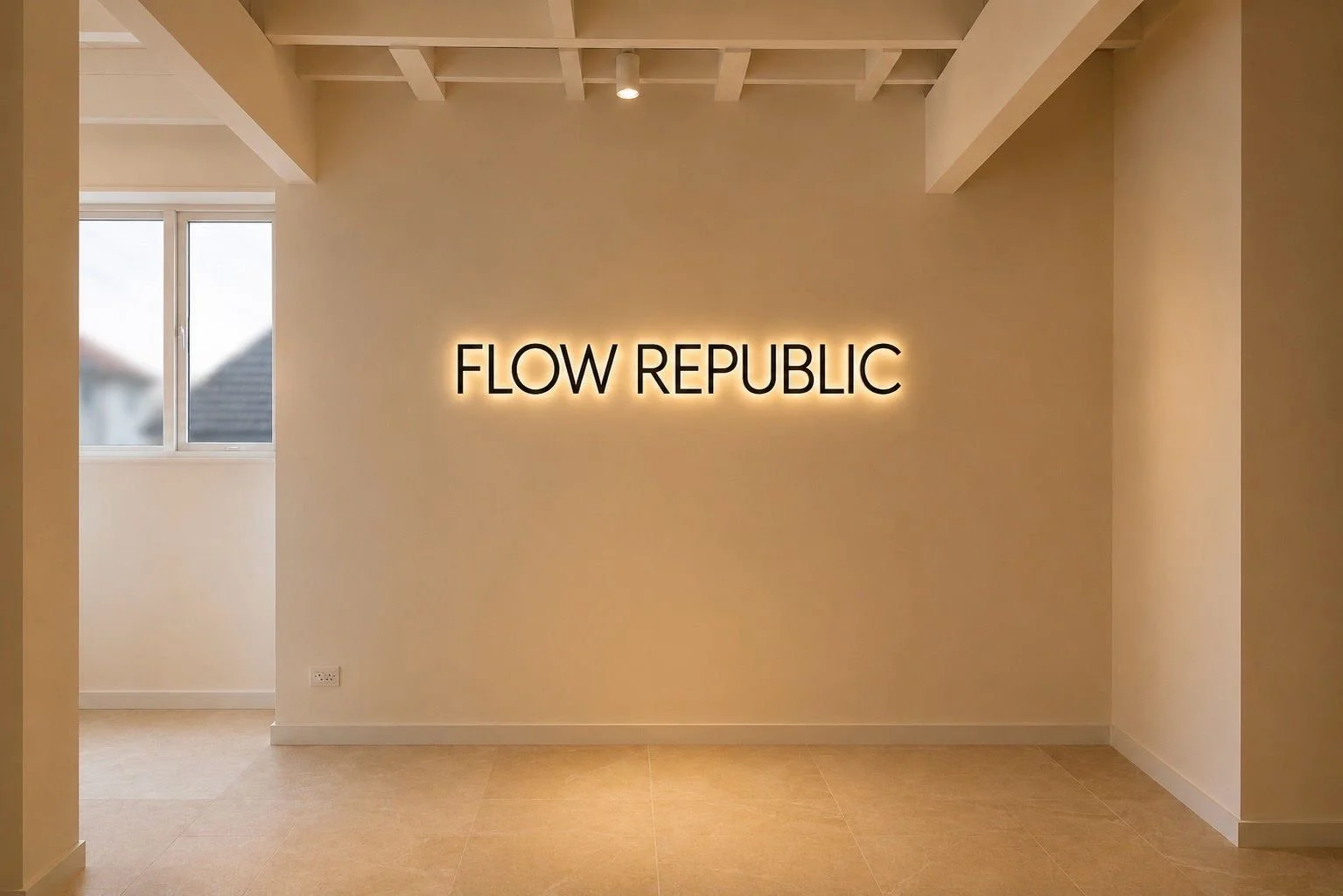 Illuminated Flow Republic studio signage set against a minimalist interior, reflecting the calm and considered design of the space.