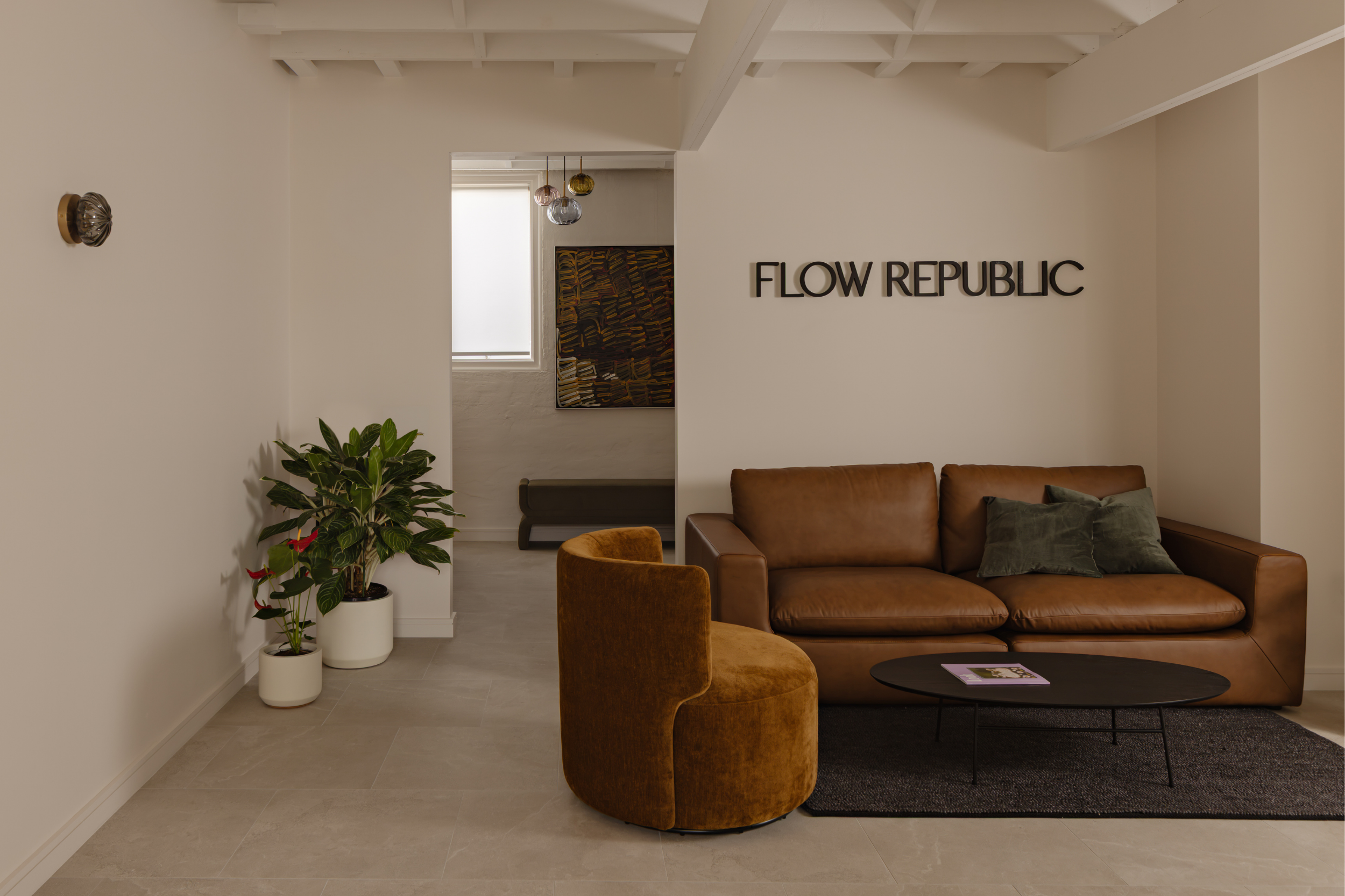 Reception area of Flow Republic, a premium yoga studio in Rozelle, Sydney, featuring a welcoming lounge and modern interiors.
